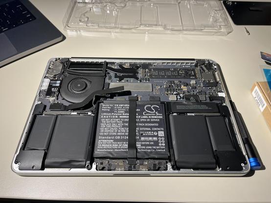 The inside of the MacBook with the new battery installed.
