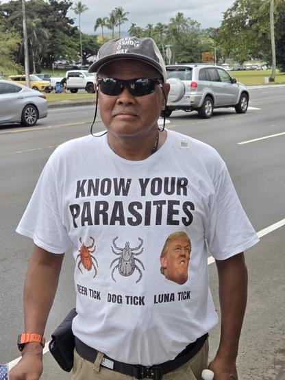 Man wearing a t-shirt reading "Know Your Parasites." Below that are 3 pictures: The first 2 are insects, labeled "deer tick" and  "dog tick." The 3rd shows Donald Trump and is labeled "Luna Tick."