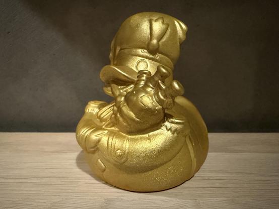 A gold coated rubber duck playing bagpipes — the first prize given in TRSAC 2025’s Freestyle Graphics Competition.