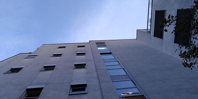 Fassade eines generisch aussehenden grauen Gebäudes.