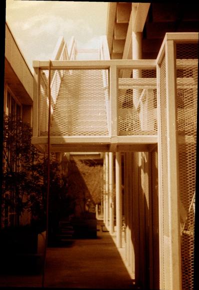 Redscale image of an elevated outdoor steel stairway above an inner courtyard in shadow.

📷️ Olympus Pen F
🎞️ Harman RED 125