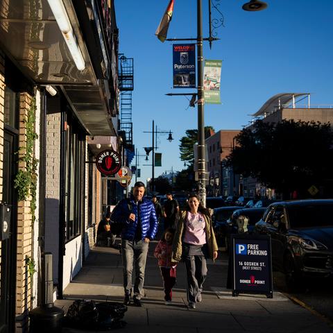 People walked on Main Street, a section of which is named Palestine Way, in Paterson, N.J., which has one of the largest Palestinian communities in the country.