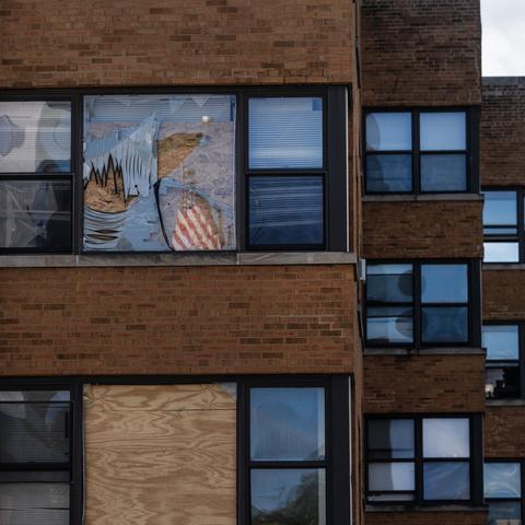 Windows are boarded up at an apartment building in Chicago’s South Shore neighborhood where federal agents staged a massive raid.