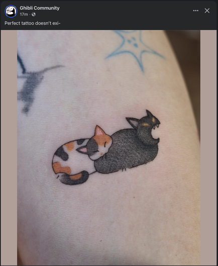 Tattoo of cat biting cat.