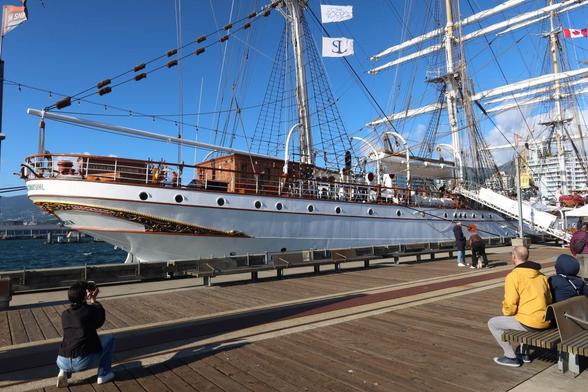 Close up of the back half of the ship. Multiple people are taking photos.