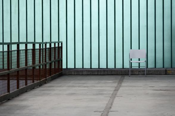 A chair in front of a glass wall