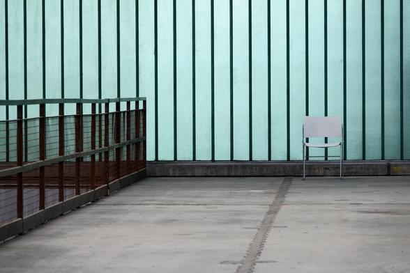 A chair in front of a glass wall