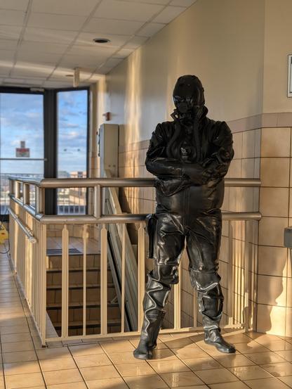 Nyxie in a heavy rubber dry suit and gas mask.