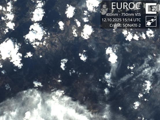 A color picture of earth taken in the visible optical spectrum by satellite SONATE-2. It shows a region around Campo Militar de Santa Margarida, some dozen kilometers in size, with bigger landmarks like rivers and country roads being recognizable below some layers of scattered clouds.
An overlay in the top right corner reads:
EUROC
400nm - 750nm VIS
12.10.2025 15:14 UTC
Credit: SONATE-2