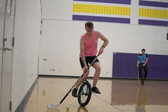 playing unicycle hockey on a 20” uni
