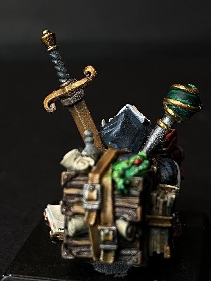 The Gnome has a wooden case strapped to his back with more paraphernalia, like a frog  and scrolls.