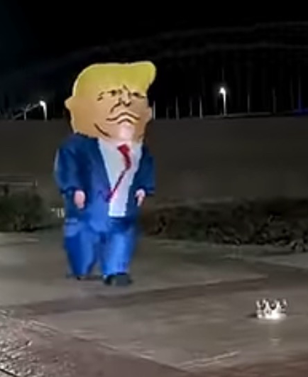 This is a short video of someone in an inflatable Trump costume, trying to catch a crown that has been moved as he gets closer