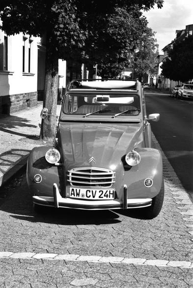 A vintage car with a roll-back roof