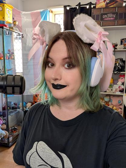 Revy wearing black eyeshadow and black lipstick and cat ear headphones