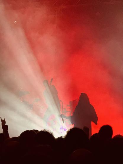 Igorrr vocalist on stage silhouetted against red-lit smoke