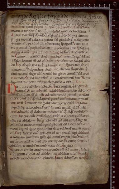 A page from a medieval manuscript. The main text is in black ink with one intitial at a paragraph break in red. At the top of the page is a later headline about the book in which this page was reused as a wrapper.