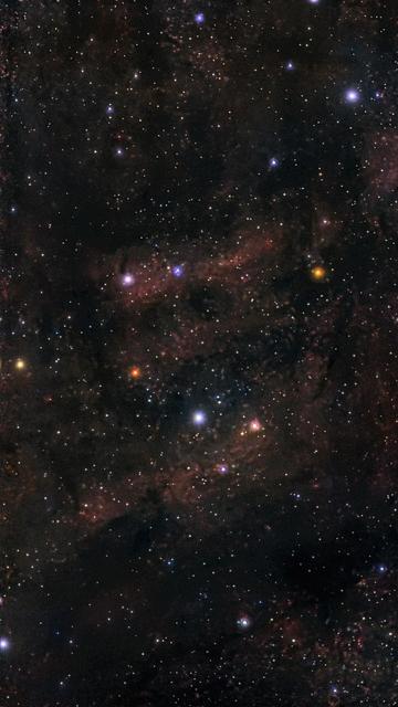 A deep space image featuring a rich field of stars, nebulae, and cosmic dust, set against a dark backdrop of the universe. Various star colors, including blue and orange hues, are visible among the scattered points of light.
Obraz głębokiego kosmosu przedstawiający bogate pole gwiazd, mgławic i kosmicznego pyłu, osadzony na ciemnym tle wszechświata. Różne kolory gwiazd, w tym odcienie niebieskiego i pomarańczowego, są widoczne wśród rozproszonych punktów światła.