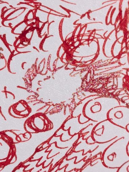 A close up of the line art, done in a rich red ink, with a silvery gold sparkle.