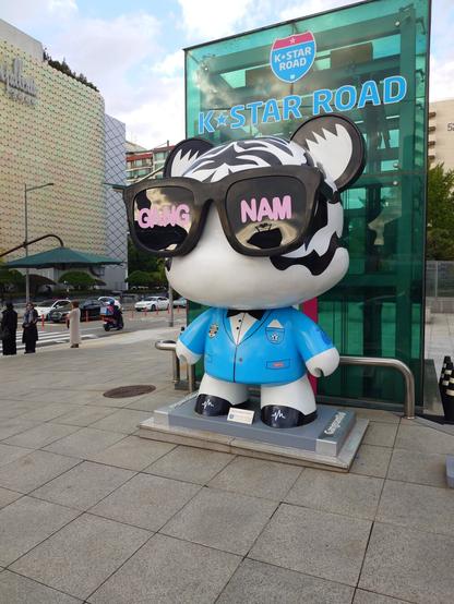 The K star Road in Gangnam. A big Gangnamdoll featuring Psi is located at the beginning of the road against the elevator to the subway.