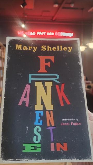 A paperback of Shelley's Frankenstine, with colurful lettering on a black background