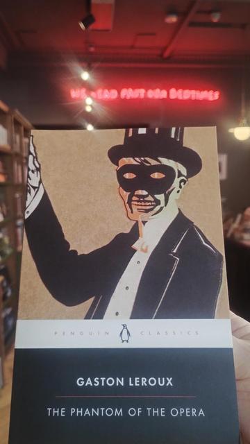 Penguin Classic edition of Leroux's The Phantom of the Opera, with a man in Victorian evening dress and top hat, with a domino mask concealing his features
