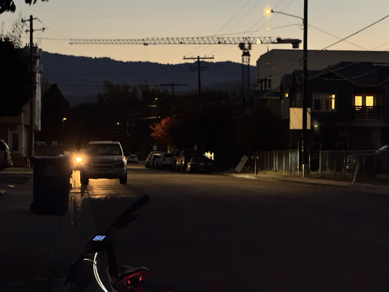 A large crane appears to be above the foothills in the background, my bike in the foreground. Photo taken riding N on 43rd St in Garden City.