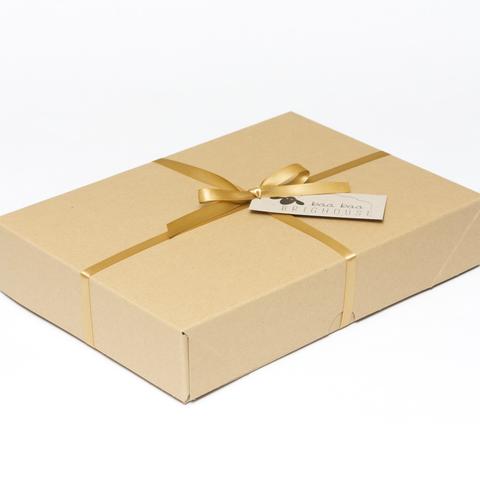Picture shows a closed A4 box tied with gold ribbon.