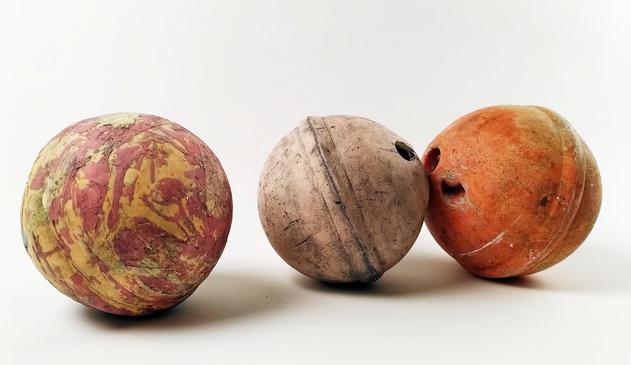3 fishing buoys on display on a white background.
The 2 on the left side are handmade ceramic copy of the original orange one on the right.