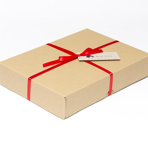 Picture shows a closed A4 box tied with red ribbon.