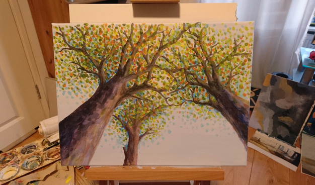 3 trees, seen from below, the leaves forming a bit of a canopy above the viewer. Lots of bright colors.