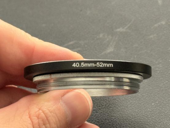 The threaded insert that goes into the adapter ring, with a 40.5-52mm filter step up ring squeezed into it