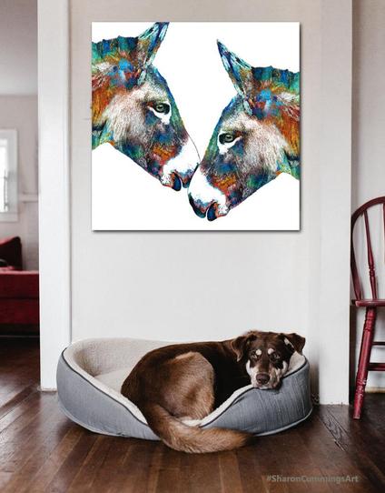 Colorful donkey heads intersecting over a dog in a bed by artist Sharon Cummings.