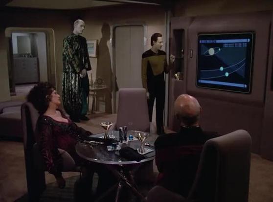 From Star Trek Next Generation s02e19. Commander Data is giving a presentation to a very bored Lwaxana Troi , Captain Picard and Mr Homn. She is slumped in her chair across from the Captain while Mr. Homn looks on from the background left.