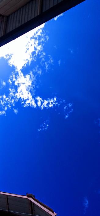 The photograph shows a magnificent view of the sky, predominantly blue in color. Scattered across the blue expanse are numerous white clouds. The clouds appear to be a mix of shapes and sizes, some puffy and others wispy. In the lower portion of the image, a section of a roof or building overhang is visible, cut off at the bottom of the frame. The perspective is looking upward, capturing a portion of the sky and a small section of a structure.

Provided by @altbot, generated privately and locally using Gemma3:12b

🌱 Energy used: 0.366 Wh