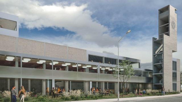 Render do projeto Factoría Moza no que se ve um prédio de três andares e a característica torre de práticas de bombeiros. Fora do prédio há gente a falar em mesas, em um jardim.