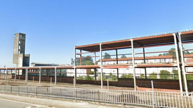 Foto do estado atual do prédio do que foi um projeto falido de parque de bombeiros. Um esqueleto de ferros e uma torre de práticas feita em formigão.