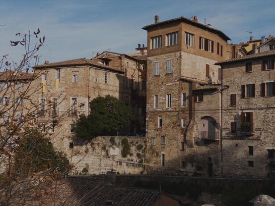 A panoramic view of Perugia, showing some old buildings incorporated into the Etruscan walls. The sky is mostly clear with a thin veneer of humidity.
The picture is shot with an iPhone 16e using No Fusion with an AgX LUT.
