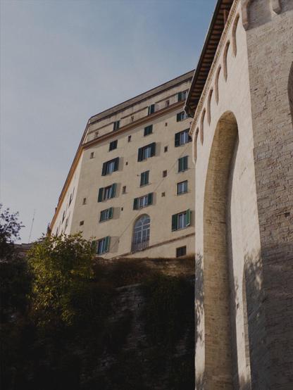 A panoramic view of Perugia, showing the side of the hexagonal church of Sant’Ercolano. The sky is mostly clear with a thin veneer of humidity.
The picture is shot with an iPhone 16e using No Fusion with an AgX LUT.