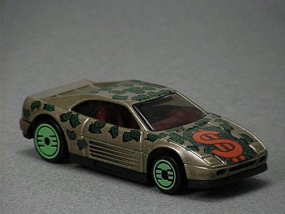 Released in 1993, Bronze Ferrari 348 of Revealers with Ultra Hot wheels. Tampo: Red dollar sign on hood, green and black dollar bills all over car. Packaging: Revealer 10 Pack. Metal Body, Plastic Base. Made in Malaysia. Scarcity: 2/10