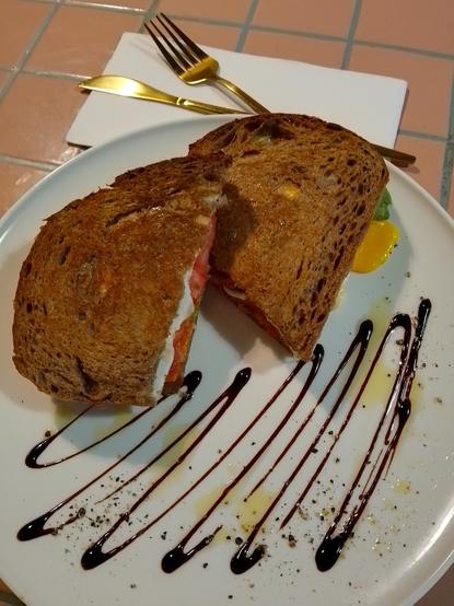 Adge's signature - toasties with hot salami, fried egg, avocado, fresh tomatoes and cheese