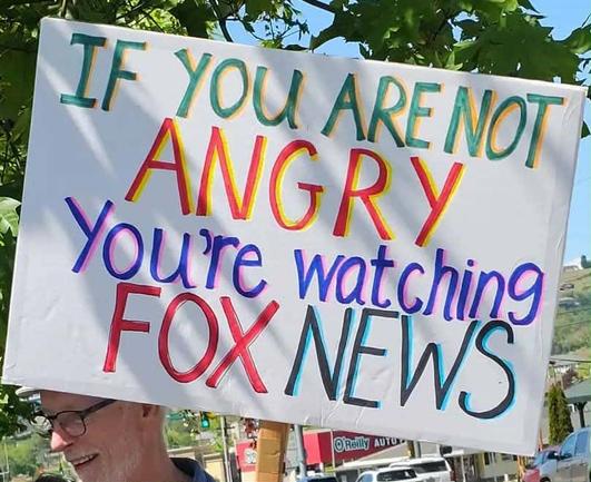 a sign that says if you are not angry you're watching fox news