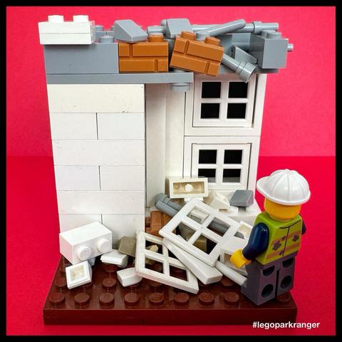A Lego minifigure in a hardhat stares at the demolition of the White House East Wing