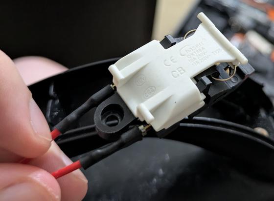 top view of the switch. it's a large switch - about 1 inch (2.5cm) wide and even longer than it is wide

the switch says:

Chaserr®
QX188A
10A 250V-
13A 250V- T125

you can also see the two electrical connectors, which are somewhat thick wires that spread into a wide "mouth" that swallows up two flat metal prongs on the switch