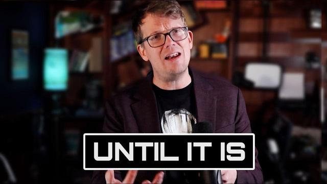 Thumbnail of the video from YouTube. It is a picture of Hank Green holding a microphone and talking to the camera, gesturing with his hands like he's explaining something. There is a text box below which reads "Until it is" in bold capital letters.
