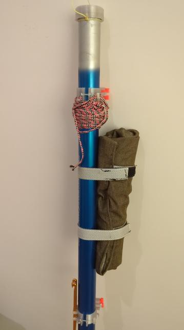 Same roll strapped to a fishing pole leaning on a wall.