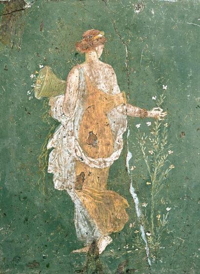 “Flora”
da Stabiae, Villa di Arianna inv. 8834
www.museoarcheologiconapoli.it

A Roman fresco from Pompeii. Painted on a green background, a young woman, wearing a loose, flowing robe of white and yellow, walks away from the viewer. In her left arm she carries a basket of flowers; her dress slips off her right shoulder as she reaches out to pluck a shoot from a tall flowering plant beside her.