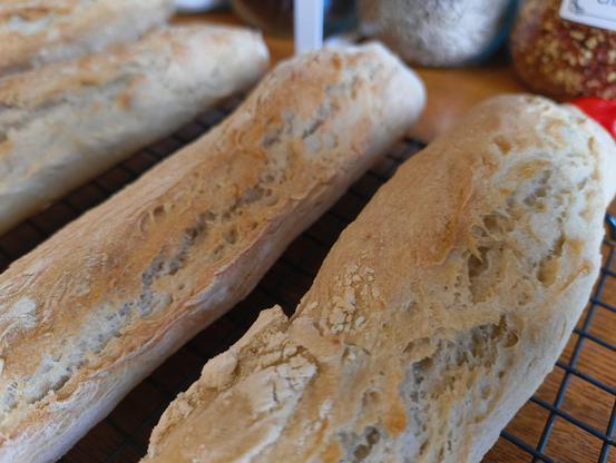 Quick baguettes cooling on a rack. They have a good texture and crunchy crusty.