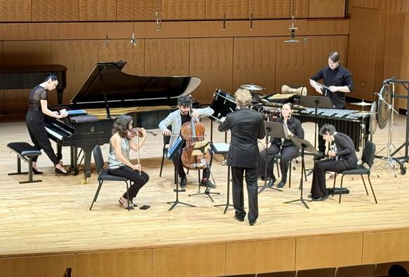 A group of musicians performs on stage.