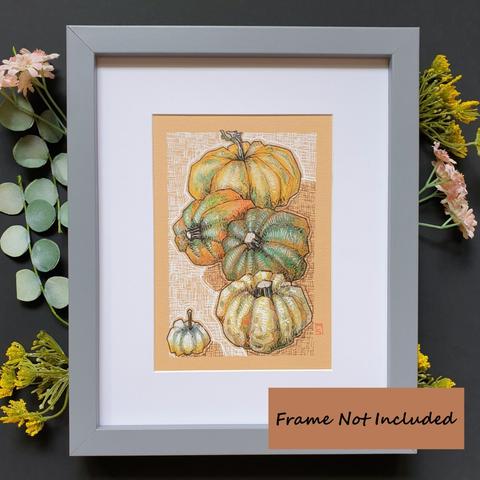 A small original drawing of a group of colourful pumpkins, orange green and white, with a background of cross hatching marks in white and brown. The drawing is on peach toned paper.
An original art work, please note that the frame is not included.
Colour pencil and mixed media on acid free toned artist paper
5 by 7 inches (12.7 by 17.8 cm).