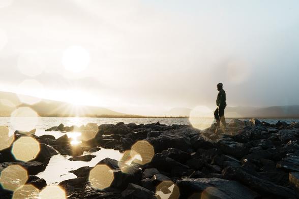 View from the Porojärvi Wilderness Hut looking toward the Meekon Valley in Finland, showing wide open fjells and rugged northern landscape under clear light.